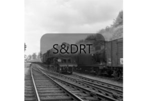 Midsomer Norton South; 92245 on 1O94 Bradford-Bournemouth service running through station - Jinty in siding, 1962; G A Richardson